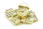 Time is money concept with dollars and clock